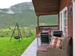 a porch with chairs and a view of a mountain at Holiday Home Peer Gynt by Interhome in Sogndal +11 photos