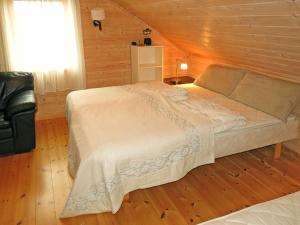 a bedroom with a bed in a wooden room at Holiday Home Peer Gynt by Interhome in Sogndal