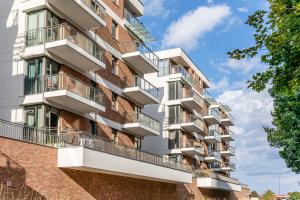 an apartment building with balconies on the side of it at Apartament Old Town Nest in Gdańsk
