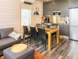 a kitchen and living room with a table and chairs at Holiday Home Villa vuosseli b 1 by Interhome in Ruka