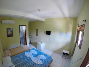 a bedroom with a blue bed and green walls at Pousada Portuguesa in Natal