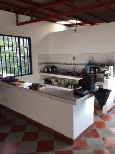 a kitchen with a counter top in a room at Finca Cafetera Las Mercedes in Cumaca