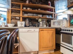 a kitchen with a stove and a white dishwasher at Holiday Home Ylläsparit as- 2 by Interhome in Ylläsjärvi