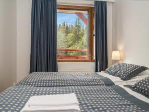 a bedroom with a bed and a window with a view at Holiday Home Ylläs chalets a307 by Interhome in Ylläs