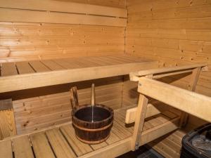 a inside of a wooden sauna with a bucket at Holiday Home Ylläs chalets a307 by Interhome in Ylläs