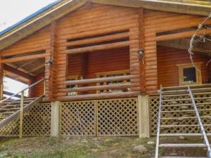 a log cabin with a gate in front of it at Holiday Home Kulpakko 1 by Interhome in Tiainen