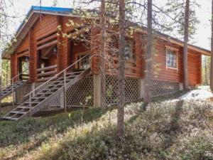a log cabin with a staircase in front of it at Holiday Home Kulpakko 1 by Interhome in Tiainen