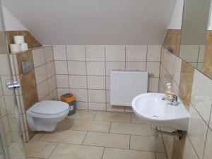 a bathroom with a toilet and a sink at U Justyny in Chróścice