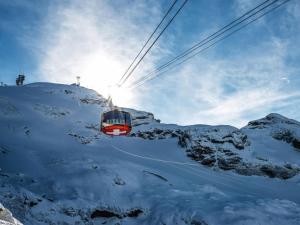 a ski lift in the snow on a mountain at Apartment Parkweg 9-102 by Interhome in Engelberg