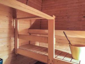 a sauna in a wooden room with a bucket at Holiday Home Lupposyöte b1 by Interhome in Syöte