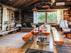 a living room with a wooden table and a couch at Holiday Home Merihovi by Interhome in Haukipudas