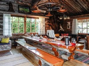 a living room with a large wooden table in a cabin at Holiday Home Merihovi by Interhome in Haukipudas