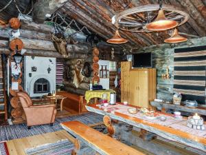 a living room with a table in a log cabin at Holiday Home Merihovi by Interhome in Haukipudas