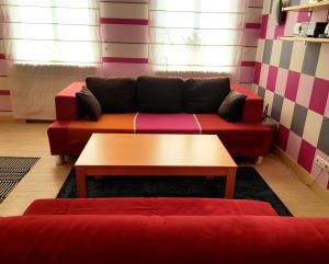 a living room with a couch and a coffee table at Fuksija House in Daugavpils