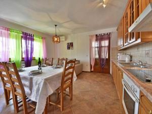 a kitchen with a table and chairs in a room at Apartment Villa Karolina by Interhome in Opric +21 photos