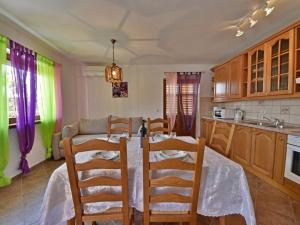 a kitchen with a table and chairs in a room at Apartment Villa Karolina by Interhome in Opric