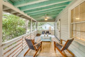 a porch with two chairs and a table at Sea Salt Cottage in Folly Beach
