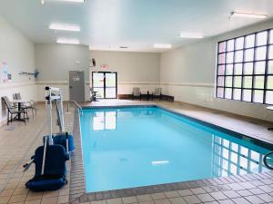 a large swimming pool with blue water in a room at La Quinta by Wyndham Minneapolis Northwest in Brooklyn Park