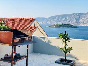 a balcony with a view of the water and a house at Apartments Mare in Korčula