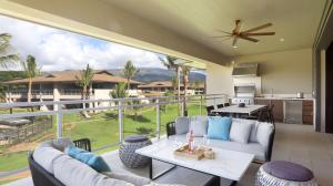 a living room with a balcony with a large window at Maui Westside Presents - Luana Garden Villas 18C in Kaanapali