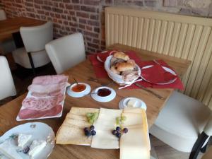 a wooden table with food on top of it at Logies Mario in Tongeren