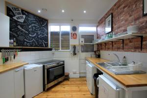 a kitchen with a black chalkboard on the wall at Central Backpackers in Oxford