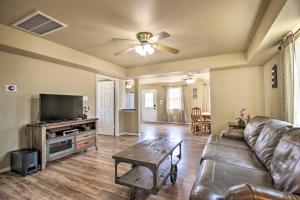 a living room with a couch and a flat screen tv at Surfside Retreat Steps to Beach and Local Eats! in Surfside Beach