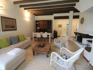 a living room with a couch and chairs and a table at Holiday Home Alpina by Interhome in Porto Valtravaglia