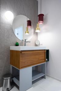 a bathroom with a sink and a mirror at City Lights Apartments in Krakow +127 photos
