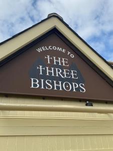 a sign that says welcome to the three bikers on a building at Three Bishops Inn in Newport