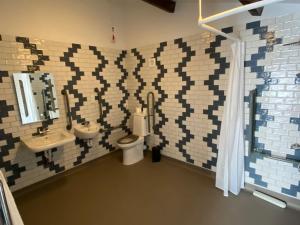 a bathroom with a toilet and a sink at Three Bishops Inn in Newport