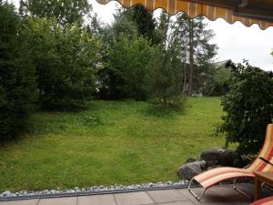 a view of a yard with a bench and trees at Apartment Zapfe - Küenzi by Interhome in Saanenmöser