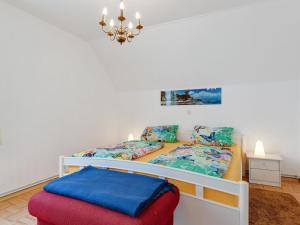 a bedroom with two beds and a stool at Cozy Apartment in Altenfeld with Garden in Altenfeld