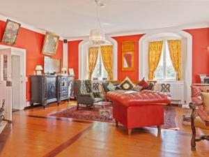 a living room with red walls and a red couch at Lavish Castle in Riedenburg with Garden near Lake in Riedenburg