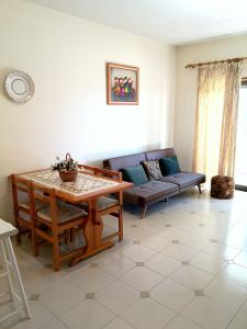 a living room with a table and a couch at Dreaming of Algarve in Porches