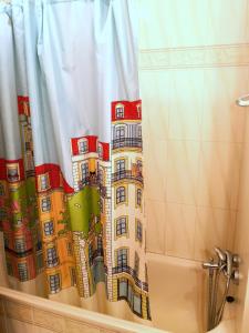 a shower curtain with a picture of a building at Dreaming of Algarve in Porches