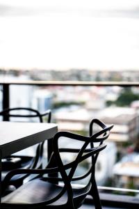 a table with chairs sitting on top of it at Opera Apartments South Brisbane in Brisbane