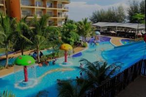 a pool at a resort with a water park at Gold Coast Rose Studio in Banting