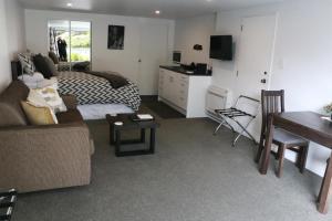 een woonkamer met een bank, een bed en een tafel bij STUDIO@746 in Queenstown