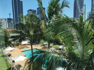 a view of a pool with palm trees and buildings at Carmel by the Sea in Gold Coast