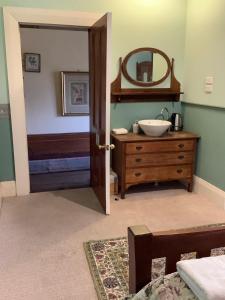 a bathroom with a sink and a mirror at Weelaway On Gregory in Geraldton