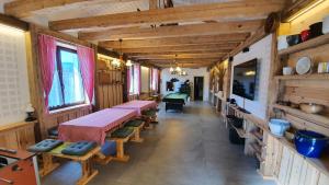 a room with tables and benches in a building at Magic House Under Arber in Bayerisch Eisenstein