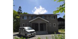 a van parked in front of a house at Cat's Villa Hakuba 2- Vacation STAY 82203 in Hakuba