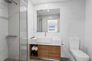 
a bathroom with a toilet, sink, and bathtub at Quest Perth Ascot in Perth
