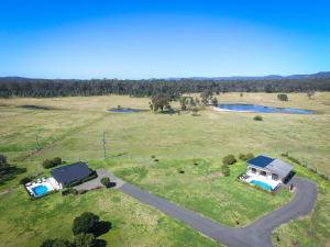 an overhead view of a house in a field with a road at Mandalay Villas - Villa 2 in Paxton