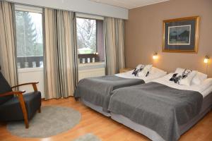 Postel nebo postele na pokoji v ubytování Revontuli Resort Rooms