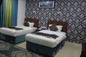 Rúm í herbergi á Al Diyar Hotel
