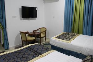 Rúm í herbergi á Al Diyar Hotel