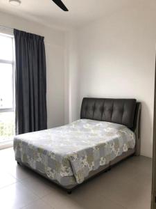 a bed sitting in a room with a window at Barrington Square 1 Room Apt @ Pasar Malam in Brinchang
