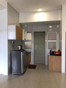 a kitchen with a refrigerator and a counter top at Barrington Square 1 Room Apt @ Pasar Malam in Brinchang